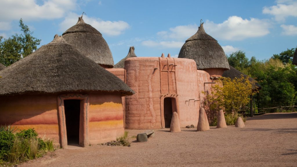 African thatched-roof huts with brown clay walls 